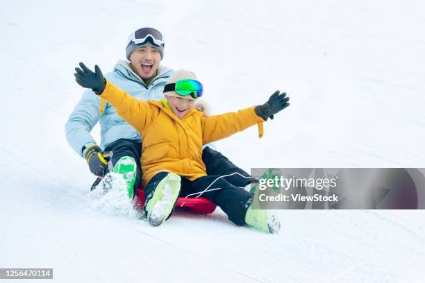 happy father and son sat snow snowboarding - chinese father and son snow stock pictures, royalty-free photos & images