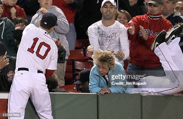 Marco Scutaro of the Boston Red Sox and Conor Jackson of the Boston Red Sox, seen falling in the stands attempt to catch a foul ball in the first...