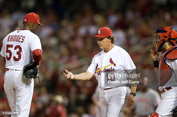 Manager Tony La Russa of the St. Louis Cardinals takes the ball from pitcher Arthur Rhodes during a game against the Cincinnati Reds at Busch Stadium...