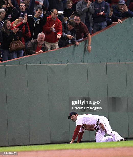 Fans react to a diving catch by Conor Jackson of the Boston Red Sox in the second game of a doubleheader against the Baltimore Orioles at Fenway Park...