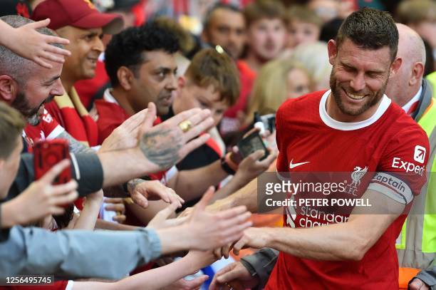 Liverpool's English midfielder James Milner acknowledges the fans after the English Premier League football match between Liverpool and Aston Villa...