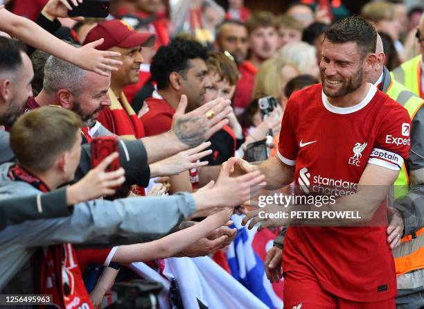 Liverpool's English midfielder James Milner acknowledges the fans after the English Premier League football match between Liverpool and Aston Villa...