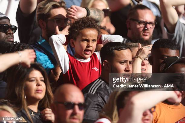 Young fan of Arsenal reacts during the Premier League match between Nottingham Forest and Arsenal FC at City Ground on May 20, 2023 in Nottingham,...