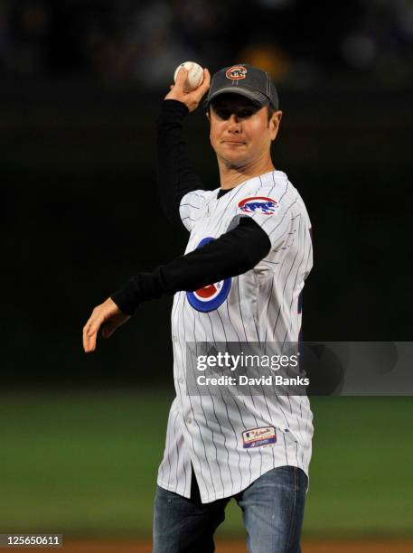 Driver Kurt Busch throws out the first pitch before the Milwaukee Brewers Chicago Cubs game on September 19, 2011 at Wrigley Field in Chicago,...