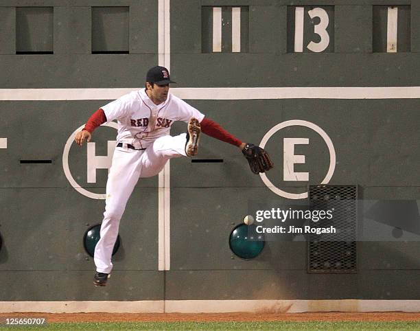 Conor Jackson of the Boston Red Sox is unable to field a ball hit by Chris Davis of the Baltimore Orioles in the second game of a doubleheade at...