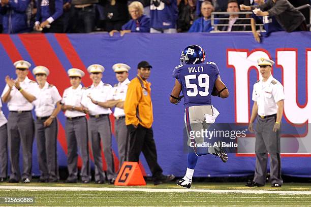 Michael Boley of the New York Giants returns a fumble 65-yards for a touchdown in the second quarter at MetLife Stadium on September 19, 2011 in East...
