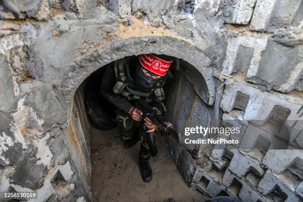 Fighters from the Democratic Front for the Liberation of Palestine walk in a tunnel in the southern Gaza Strip during preparation and preparation...