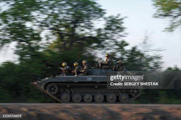 Ukrainian soldiers ride on a BMP infantry fighting vehicle toward Bakhmut, on May 20 amid the Russian invasion of Ukraine. Ukraine on May 20 said it...