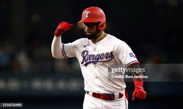 Ezequiel Duran of the Texas Rangers reacts after hitting a single against the Colorado Rockies during the first inning at Globe Life Field on May 20,...