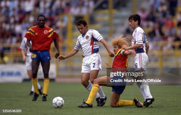June 1990 FIFA World Cup - Yugoslavia v Colombia - Colombian captain Carlos Valderrama goes down on one knee as he challenges Dragoljub Brnovic and...