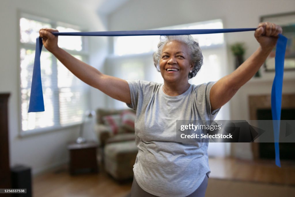 Senior african-american woman exercising inside the house