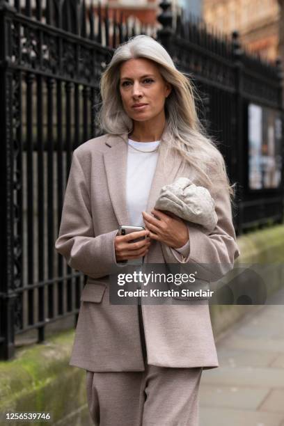 Deputy Editor and Fashion Features Director at British Vogue Sarah Harris wears a Bottega Veneta bag, white T shirt and a Roksanda Ilincic suit...