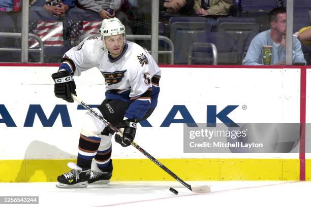 Sergie Gonchar of the Washington Capitals skates with the puck during a NHL hockey game against the Carolina Hurricanes at MCI Center on September...