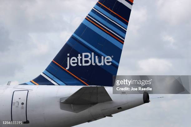 The tail of a JetBlue plane is seen as it prepares to take off from the Fort Lauderdale-Hollywood International Airport on July 16, 2020 in Fort...
