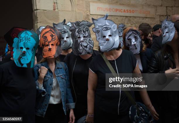 Protesters wearing masks depicting Picasso style take part in a silent protest outside the Picasso Museum, to demand better salary and working...