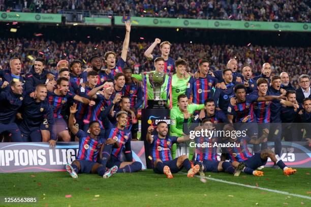 Barcelona's players poses with a Spanish trophy during the celebrations at the end of the Spanish league football match between FC Barcelona vs Real...