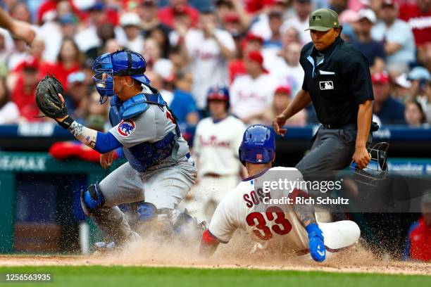 May 20: Edmundo Sosa of the Philadelphia Phillies scores on a sacrifice fly hit by Josh Harrison as catcher Yan Gomes of the Chicago Cubs waits for...