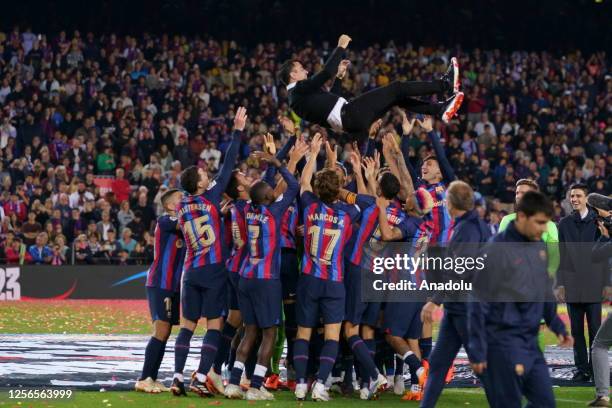 Barcelona's players poses with a Spanish trophy during the celebrations at the end of the Spanish league football match between FC Barcelona vs Real...