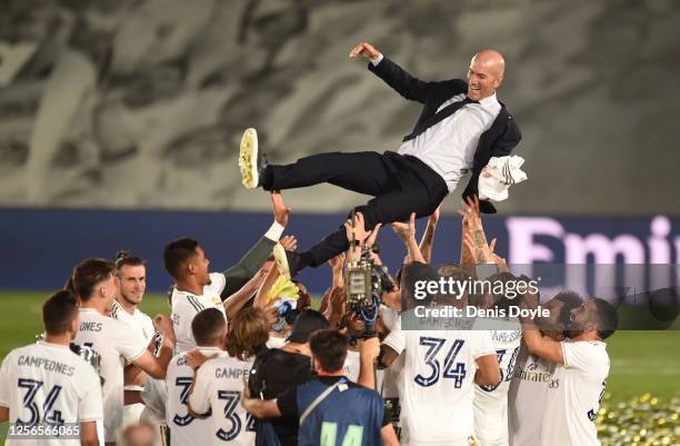 Real Madrid head coach Zinedine Zidane is thrown up in the air by his players after Madrid secure the La Liga title during the Liga match between...