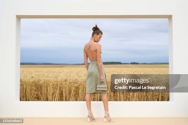 Luna Bijl poses on the first line prior to "L'Amour" : Jacquemus Spring-Summer 2021 show on July 16, 2020 in Paris, France.