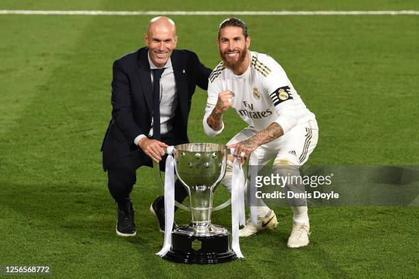 Real Madrid head coach Zinedine Zidane and captain Sergio Ramos pose with the La Liga trophy after Madrid secure the La Liga title during the Liga...