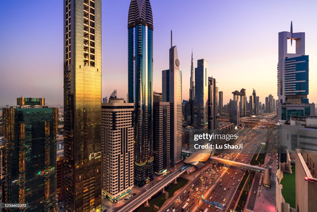 High angle views of urban skyline and skyscrapers at sunset in Dubai UAE.