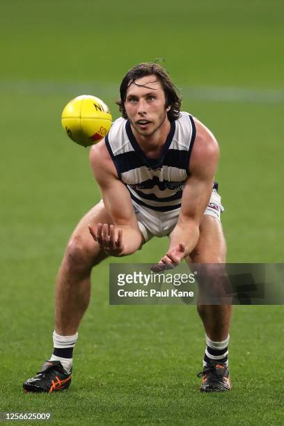 Jack Henry of the Cats marks the ball during the round 7 AFL match between the Geelong Cats and the Collingwood Magpies at Optus Stadium on July 16,...