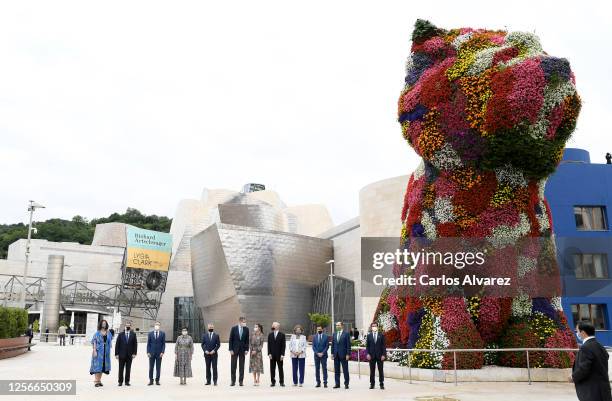 King Felipe of Spain and Queen Letizia of Spain with dignitaries and a floral sculpture called Puppy by Jeff Koons during a visit to the Guggenheim...