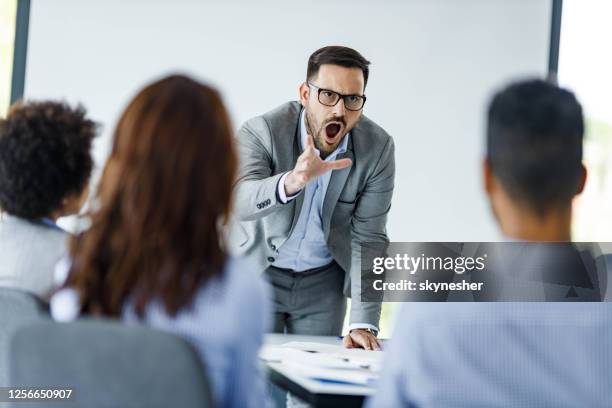 angry ceo arguing with his colleagues on a presentation in the office. - furious stock pictures, royalty-free photos & images