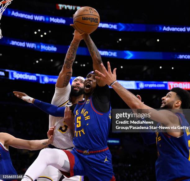 Los Angeles, CA Kentavious Caldwell-Pope of the Denver Nuggets reaches for the loose ball against Anthony Davis of the Los Angeles Lakers in the...