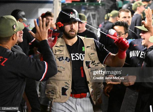 Joey Gallo of the Minnesota Twins get a fishing pole and vest after he hit a home run in the sixth inning against the Los Angeles Angels at Angel...