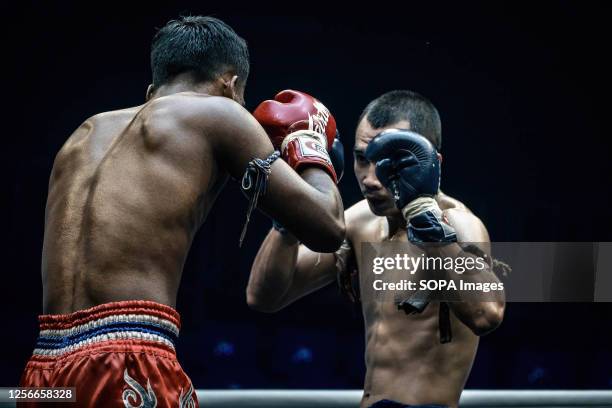 Muay Thai boxers seen during a fight, at Bangkok's Rajadamnern stadium. Muay Thai fights are held almost daily at Thailand's iconic boxing...