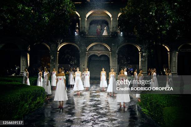 Models present creations from Christian Dior's Cruise 2024 collection during a fashion show at Colegio de San Ildefonso in Mexico City on May 20,...