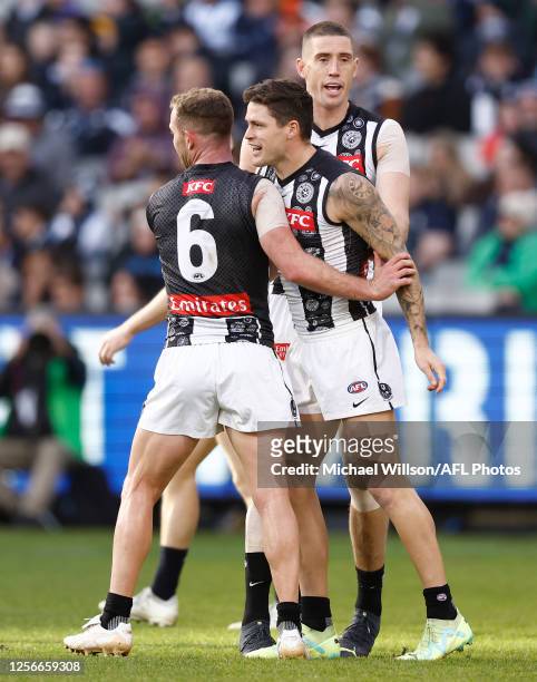 Tom Mitchell, Jack Crisp and Darcy Cameron of the Magpies celebrate during the 2023 AFL Round 10 match between the Carlton Blues and the Collingwood...