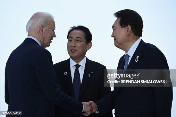 President Joe Biden, Japan's Prime Minister Fumio Kishida, and South Korea's President Yoon Suk Yeol gather for a trilateral meeting during the G7...