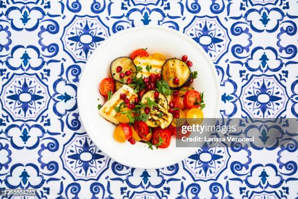 plate of tomato salad, grilled vegetables, and halloumi cheese - grilled halloumi stock pictures, royalty-free photos & images