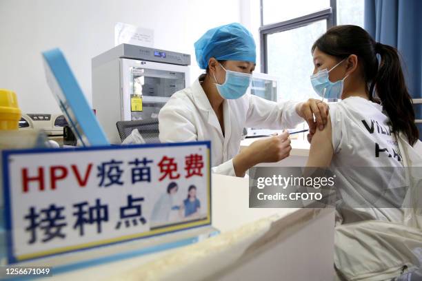 Medical workers inject Chinese bivalent HPV vaccine into school girls at a community health service center in Lianyungang, Jiangsu province, China,...