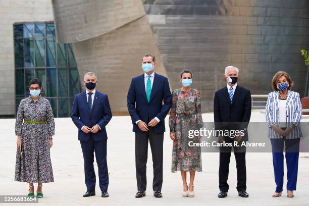 King Felipe VI of Spain Queen Letizia of Spain with dignitaries and a floral sculpture called Puppy by Jeff Koons during a visit to the Guggenheim...