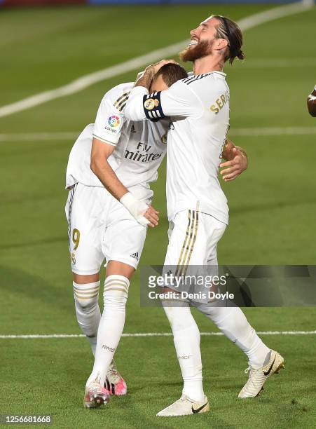 Sergio Ramos of Real Madrid congrtatulates Karim Benzema after Benzema scored the second goal from a penalty during the Liga match between Real...