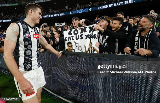 Mason Cox of the Magpies celebrates with fans during the 2023 AFL Round 10 match between the Carlton Blues and the Collingwood Magpies at the...