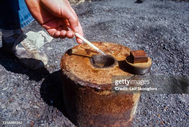 View of a sulfur dioxide detection tube held over a capped borehole from an underground coal fire , Centralia, Pennsylvania, early June, 1981....