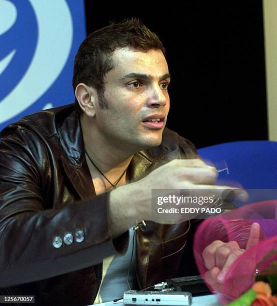 Egyptian singer Amro Diab gestures during a press conference in Dubai 15 February 2003. AFP PHOTO/Eddy PADO