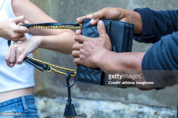 street thief stealing handbag of woman. - pickpocket foto e immagini stock