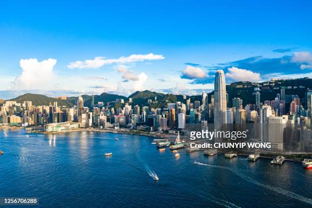 drone view of victoria harbour, hong kong - hongkong stock pictures, royalty-free photos & images