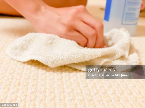 mixed-race teen girl tries to remove stain from carpet - damaged carpet stock pictures, royalty-free photos & images