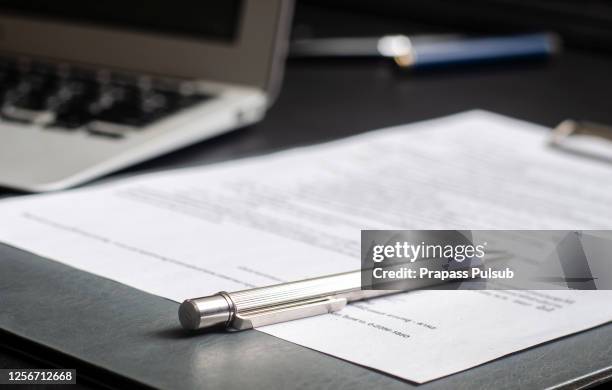 pen and signature on paper background selected focus - signing law stock pictures, royalty-free photos & images