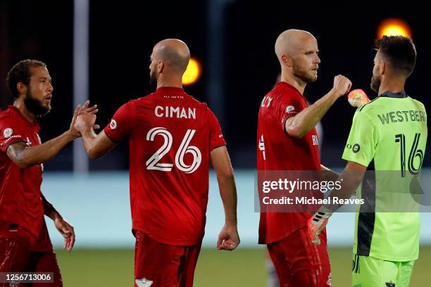 Laurent Ciman, Michael Bradley, and Quentin Westberg of Toronto FC celebrate after defeating Montreal Impact 4-3 during a Group C match as part of...