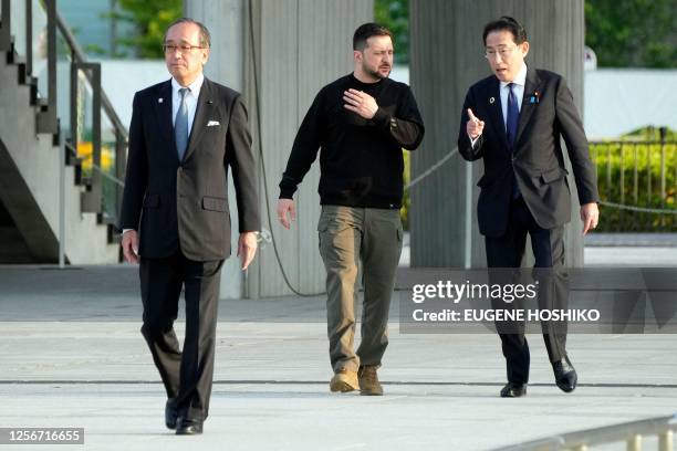 Hiroshima mayor Kazumi Matsui escorts Japan's Prime Minister Fumio Kishida and Ukraine's President Volodymyr Zelensky to the Cenotaph for the Victims...