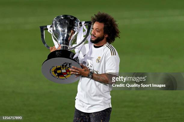 Marcelo Vieira of Real Madrid CF poses with the La Liga trophy after Real Madrid secure the La Liga title during the La Liga match between Real...