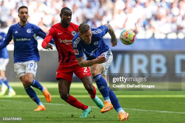 Sebastian Polter of FC Schalke 04 and Evan Ndicka of Eintracht Frankfurt battle for the ball during the Bundesliga match between FC Schalke 04 and...